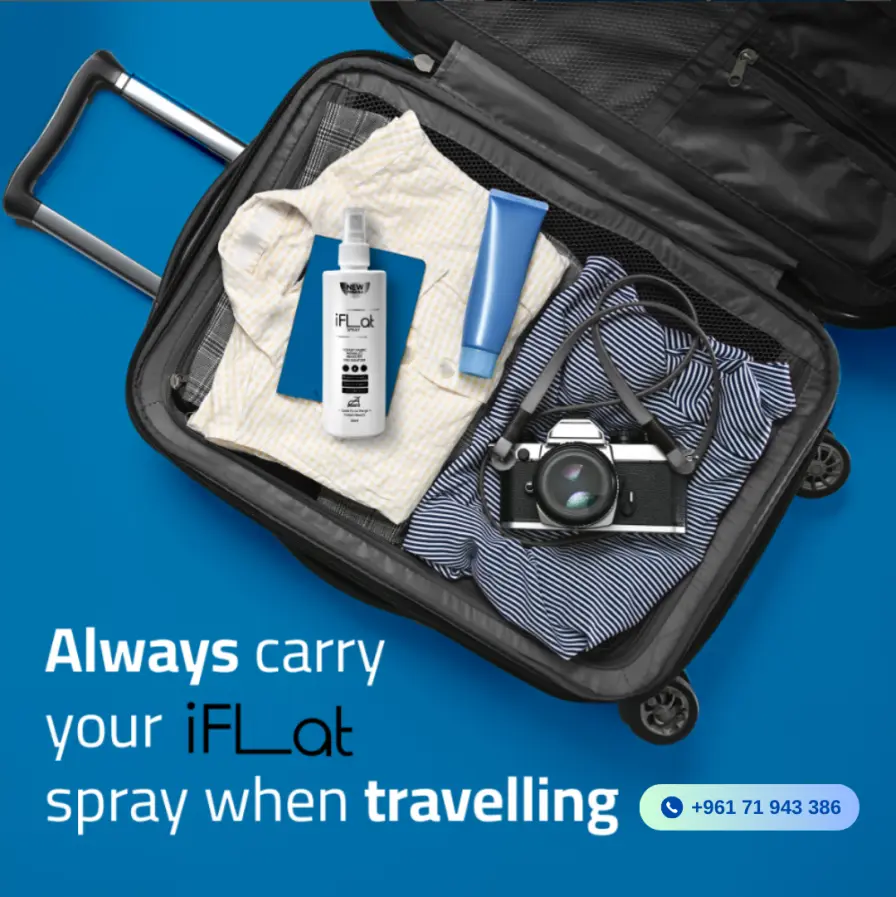 Open suitcase filled with clothes, toiletries, and a camera, featuring text about a travel spray