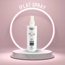 Product display of iFLAT Spray wrinkle remover with circular light on a pink backdrop